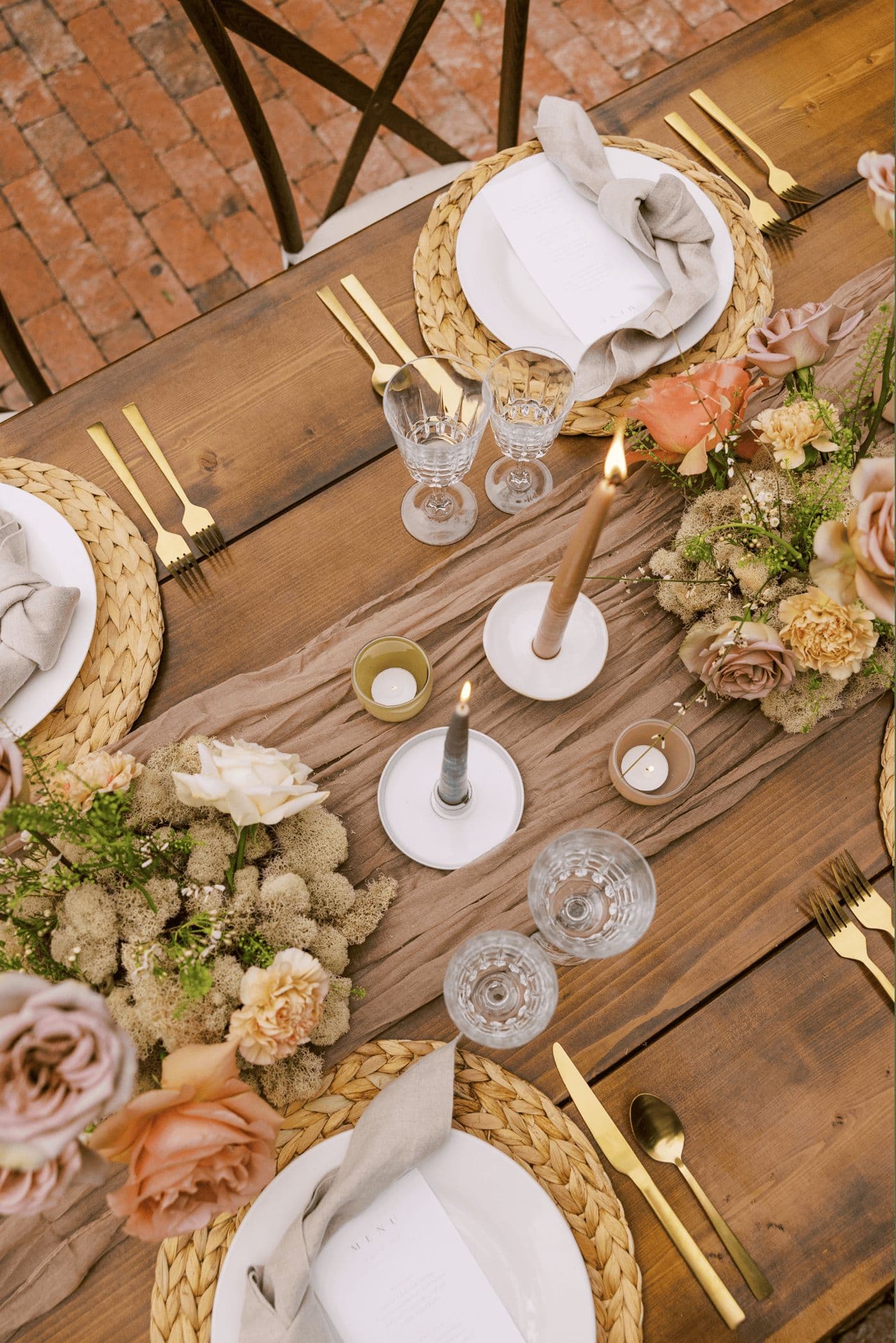A candlelit wedding reception table set for a celebration