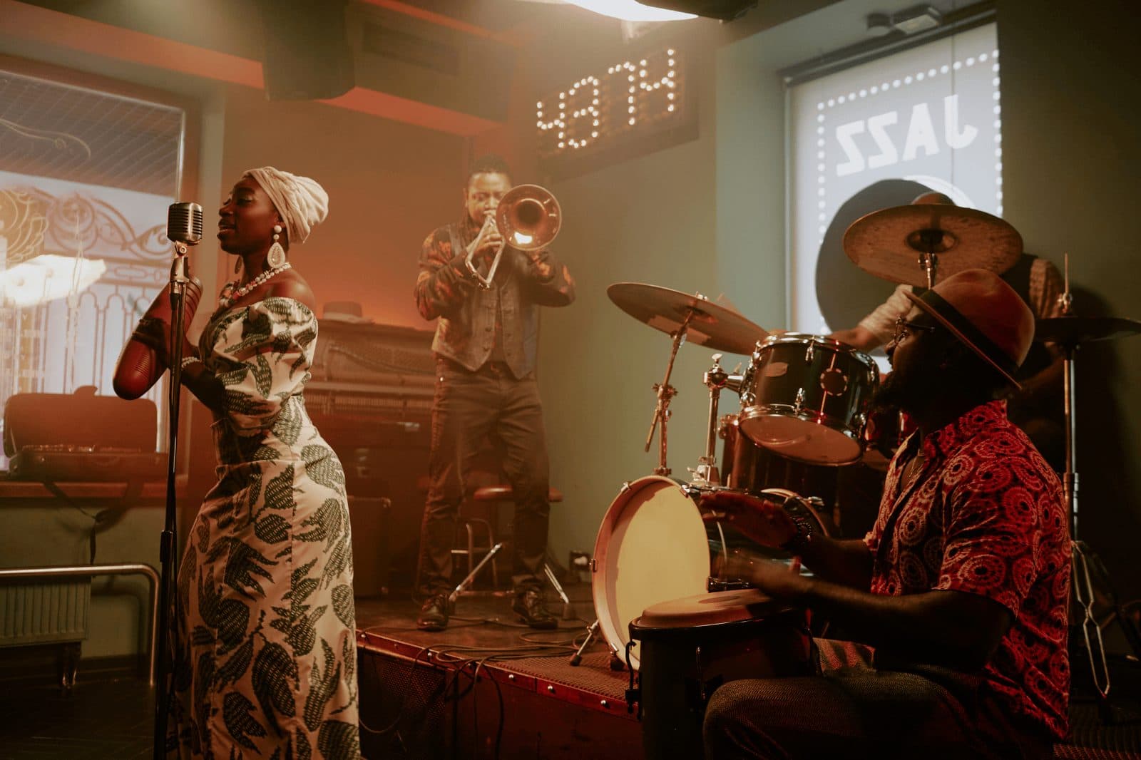 A live jazz band performing at a wedding, with a singer, trumpeter, and drummer